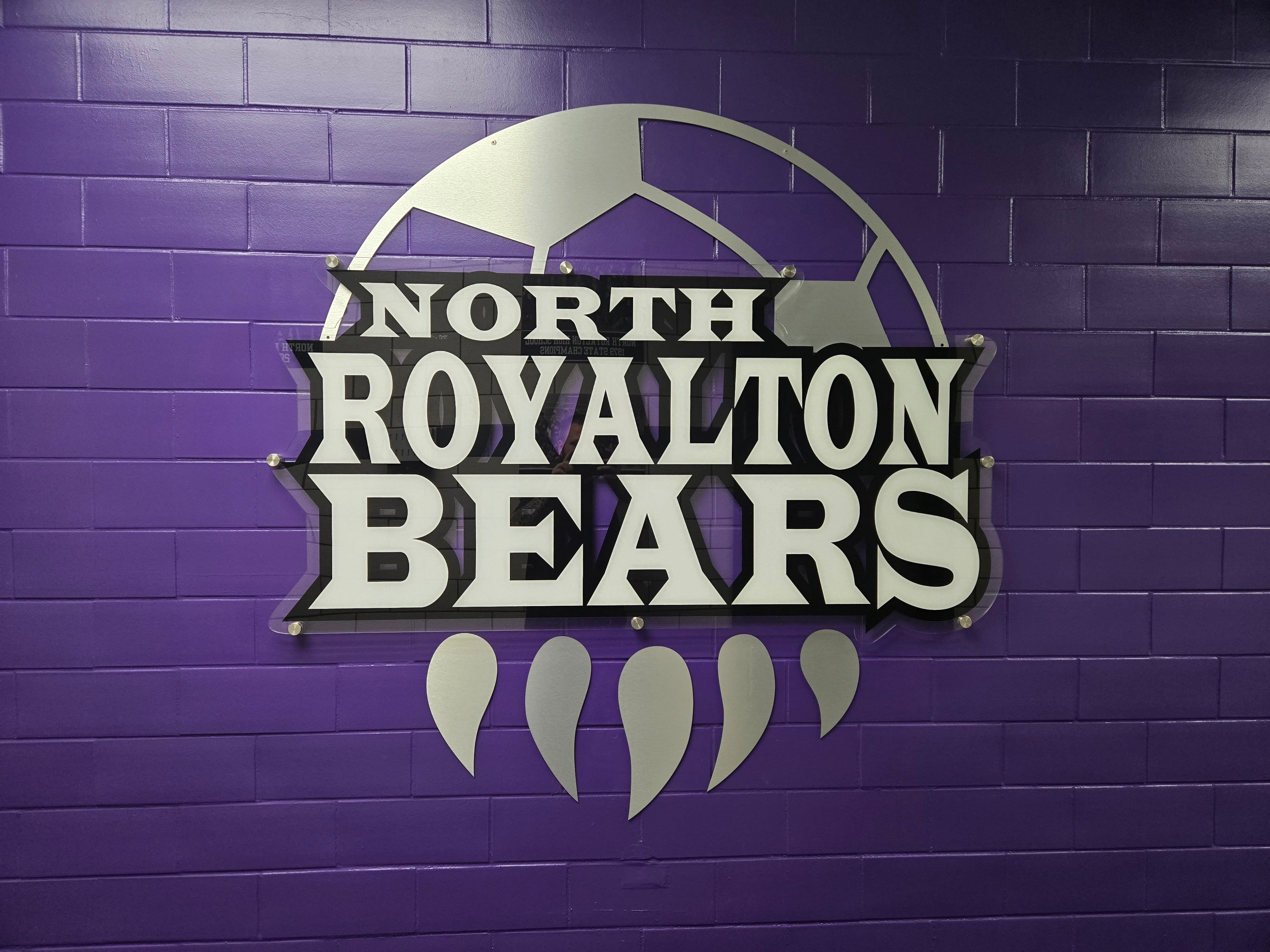 High-end architectural athletic branding using clear acrylic with opaque white ink backing