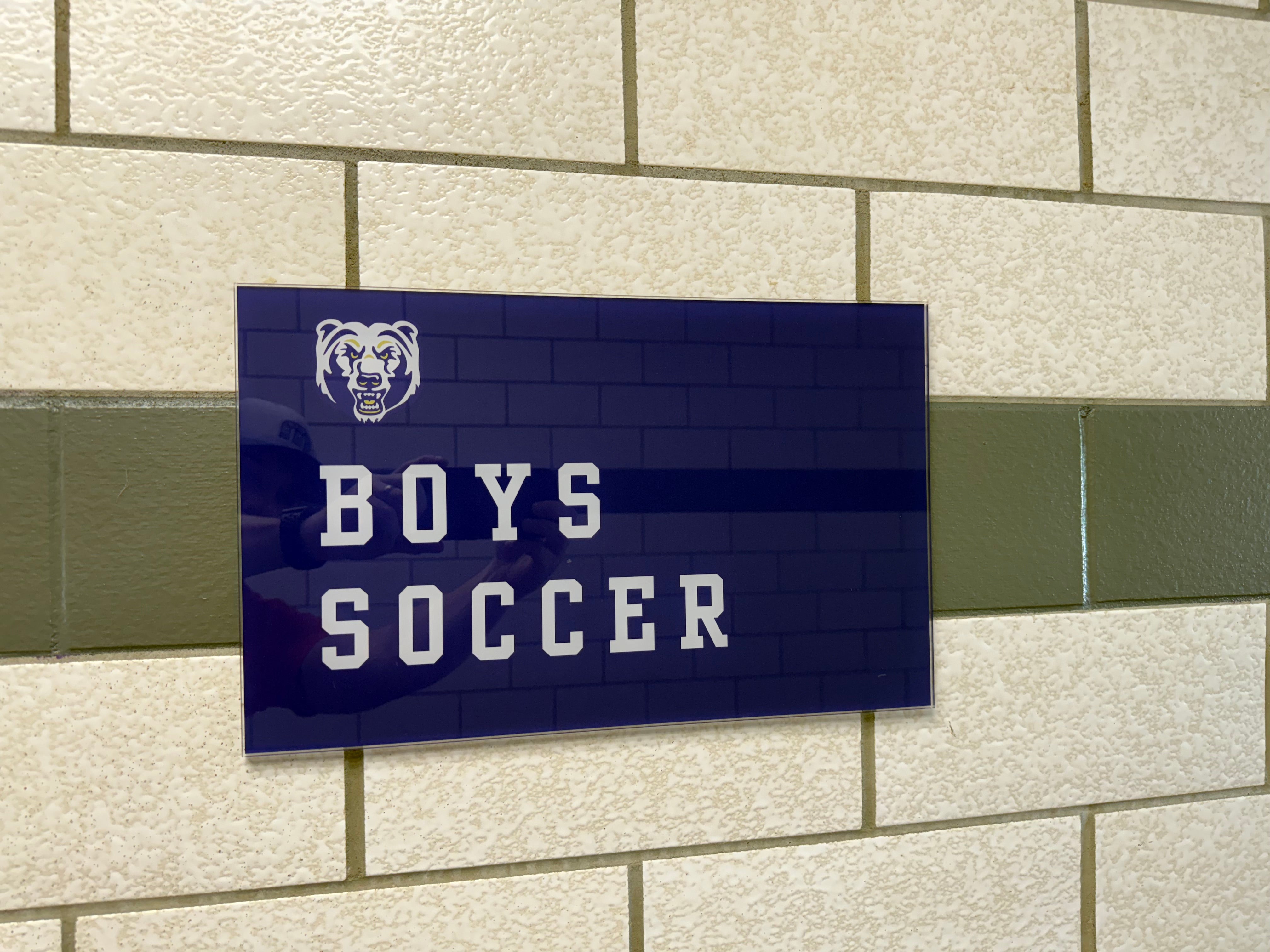 Printed Locker Room sign on clear acrylic with white ink for Boys & Girls Soccer Locker Room at North Royalton HS, in North Royalton, OH