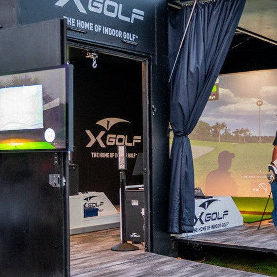 Custom branded shipping container bar and golf simulator setup for events in Ohio.